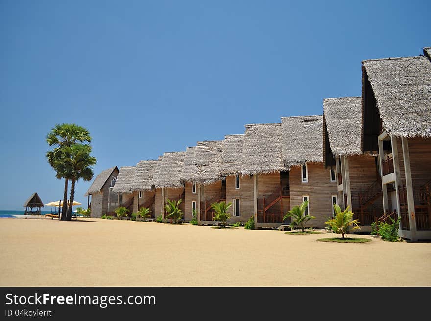 Chalet accomodation on a beach at a tropical resort. Chalet accomodation on a beach at a tropical resort