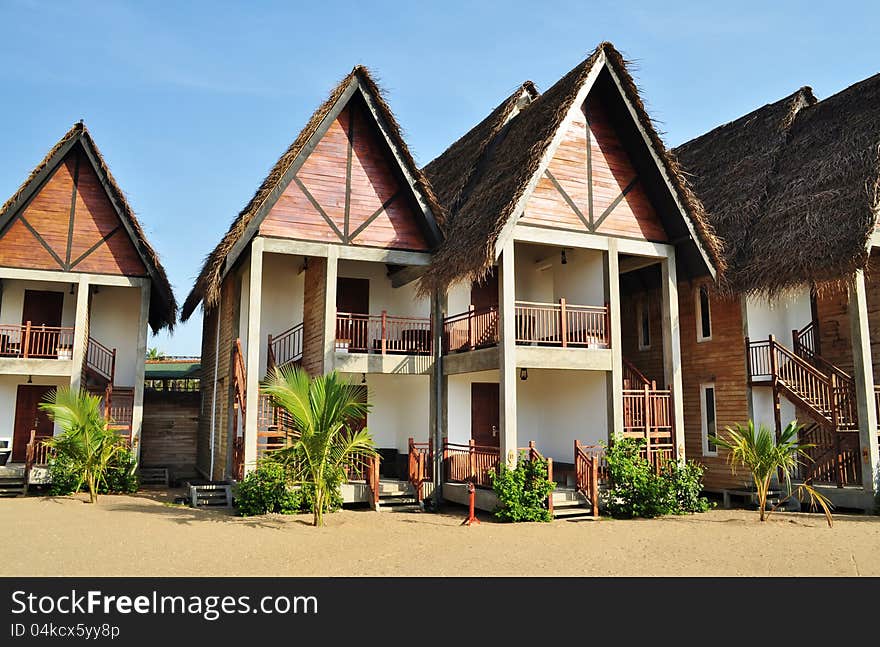 Chalet accomodation on a beach at a tropical resort. Chalet accomodation on a beach at a tropical resort