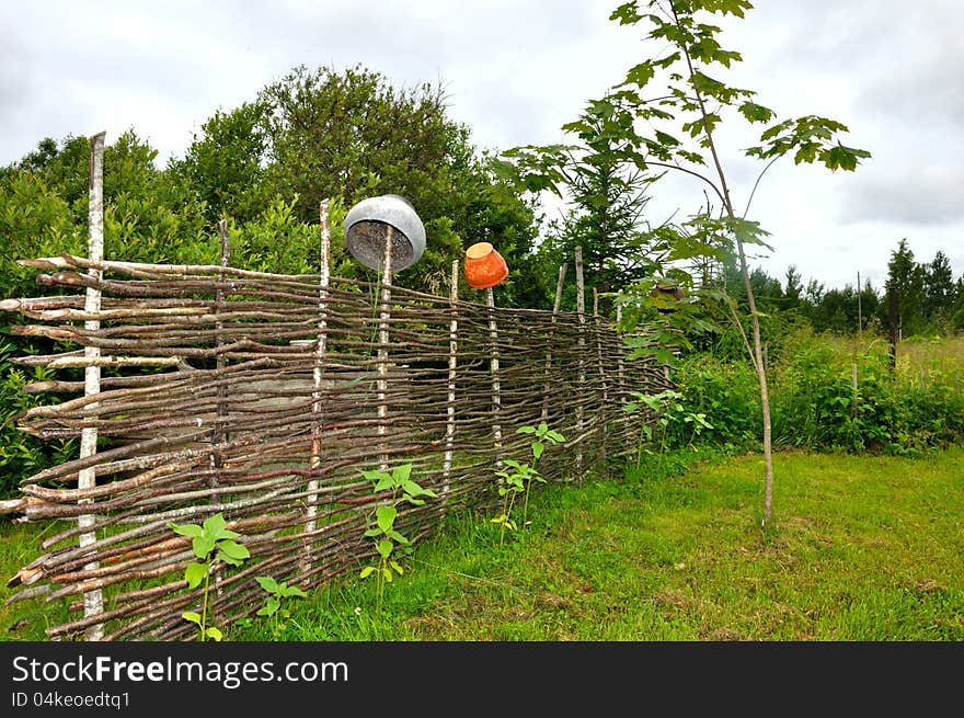 Beautiful countryside with old fence and crocks