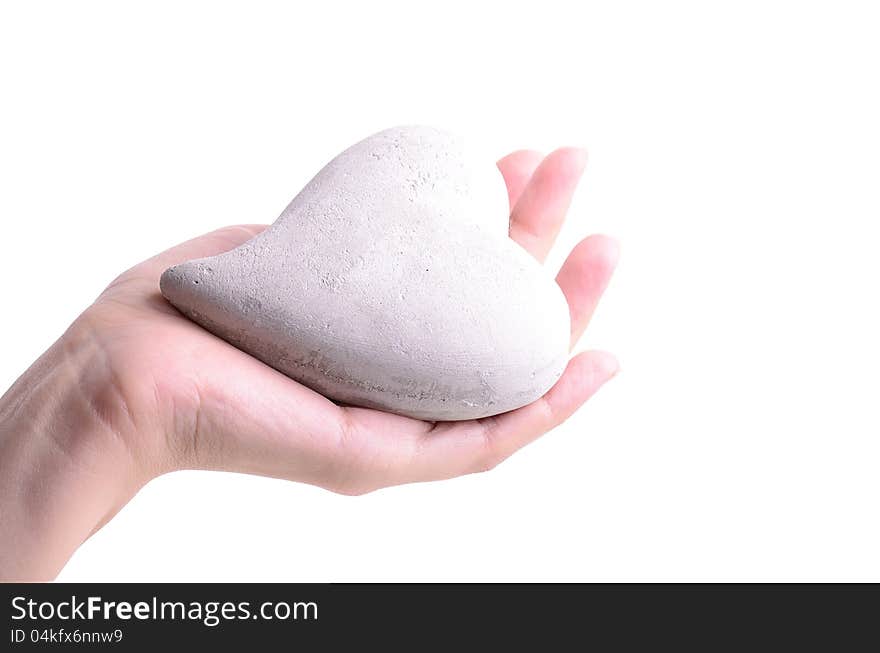 Woman holding a stone heart in his hand