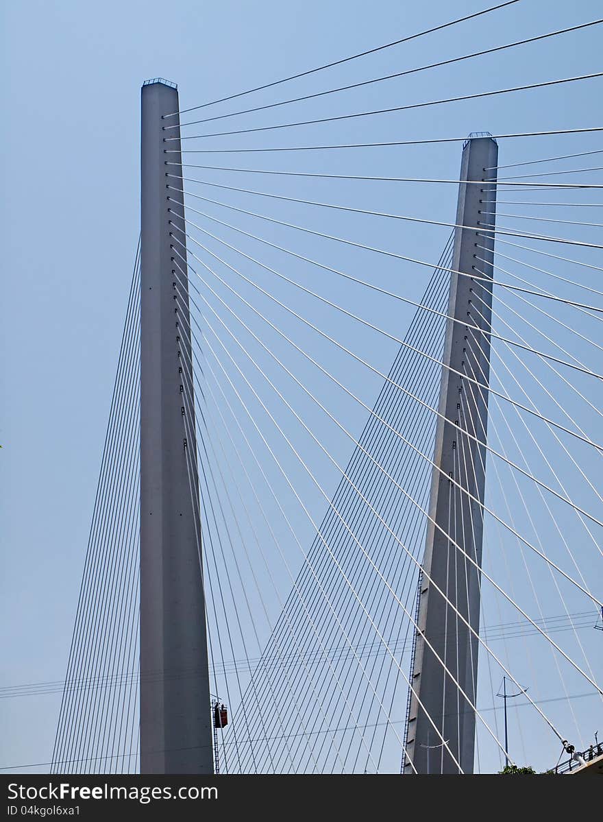 Pylons strung with guys. Detail of the bridge across the Golden Horn Bay, Vladivostok, Russian