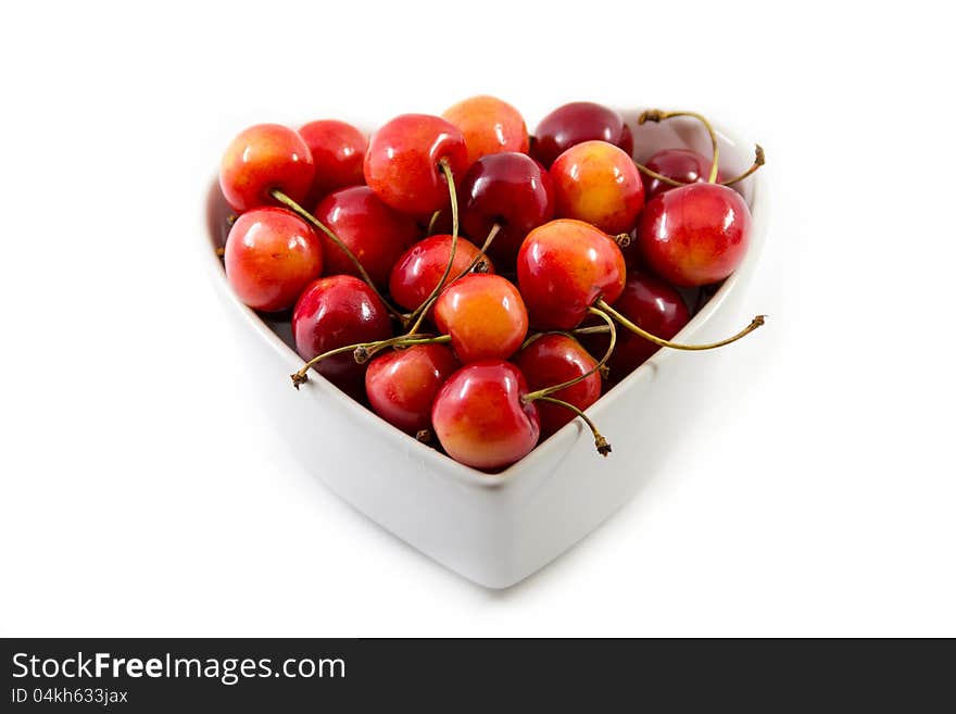 Cherries in the bowl isolated on white