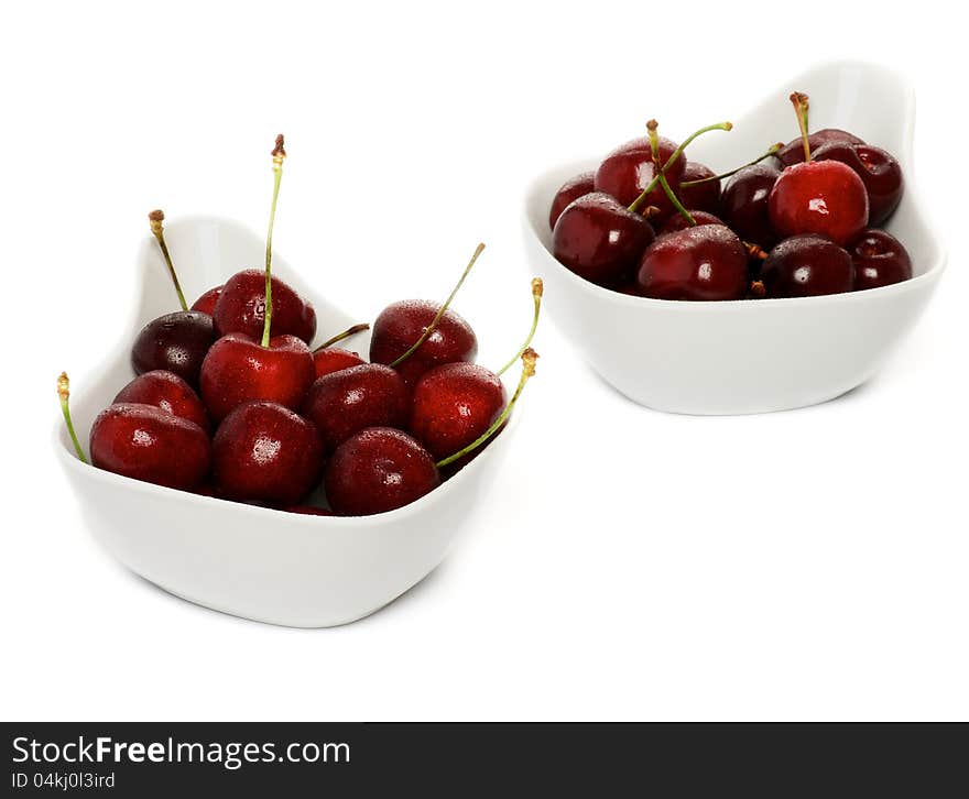 Fresh Ripe Perfect Sweet Cherry in two white bowls isolated on white background