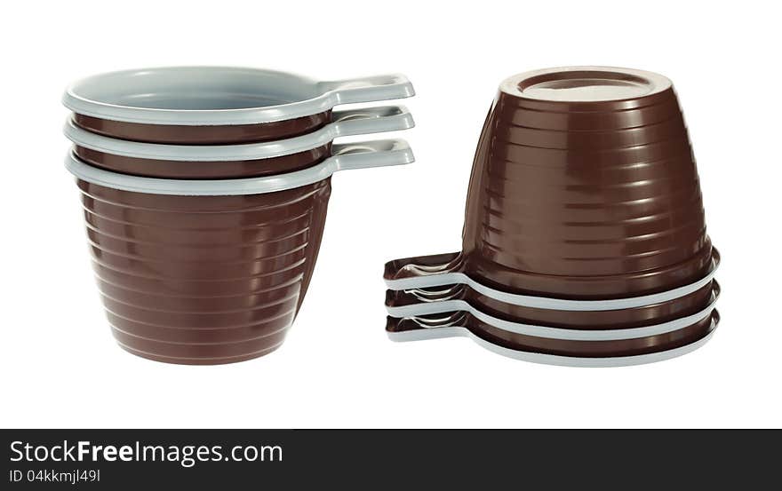 Pile of empty disposable plastic brown coffee cups isolated on white background. Pile of empty disposable plastic brown coffee cups isolated on white background