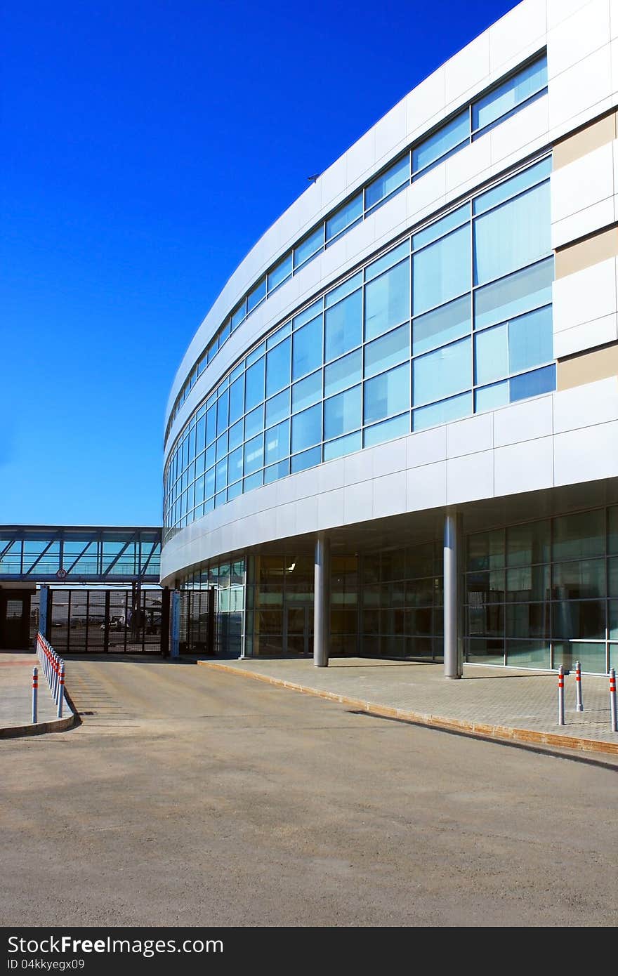 Photo of modern building of the airport against blue sky. Photo of modern building of the airport against blue sky