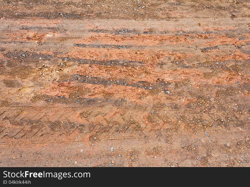 Surface of the ground at a rural road in the rain stops and traces its wheels. Surface of the ground at a rural road in the rain stops and traces its wheels.