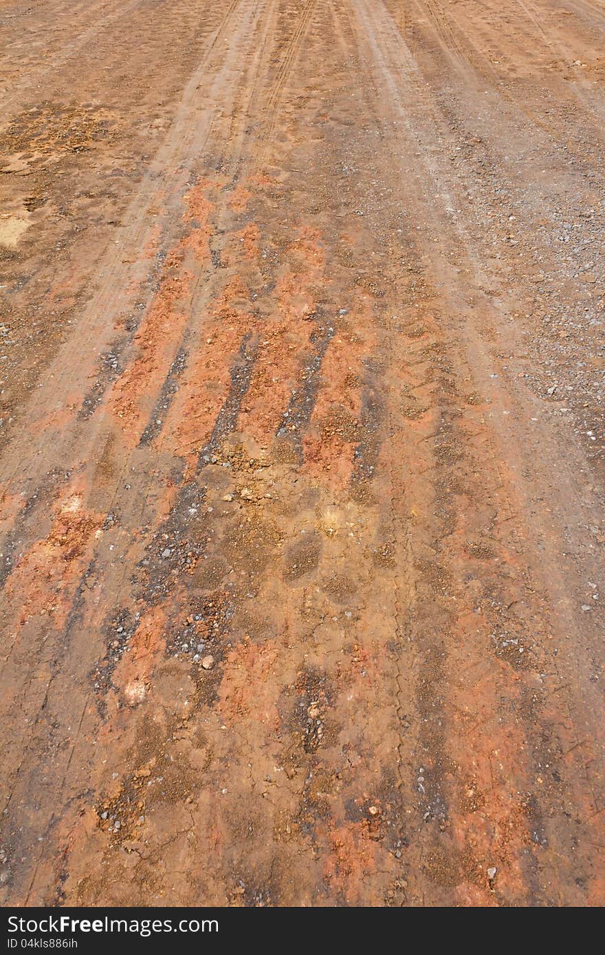 Surface of the ground at a rural road in the rain stops and traces its wheels. Surface of the ground at a rural road in the rain stops and traces its wheels.