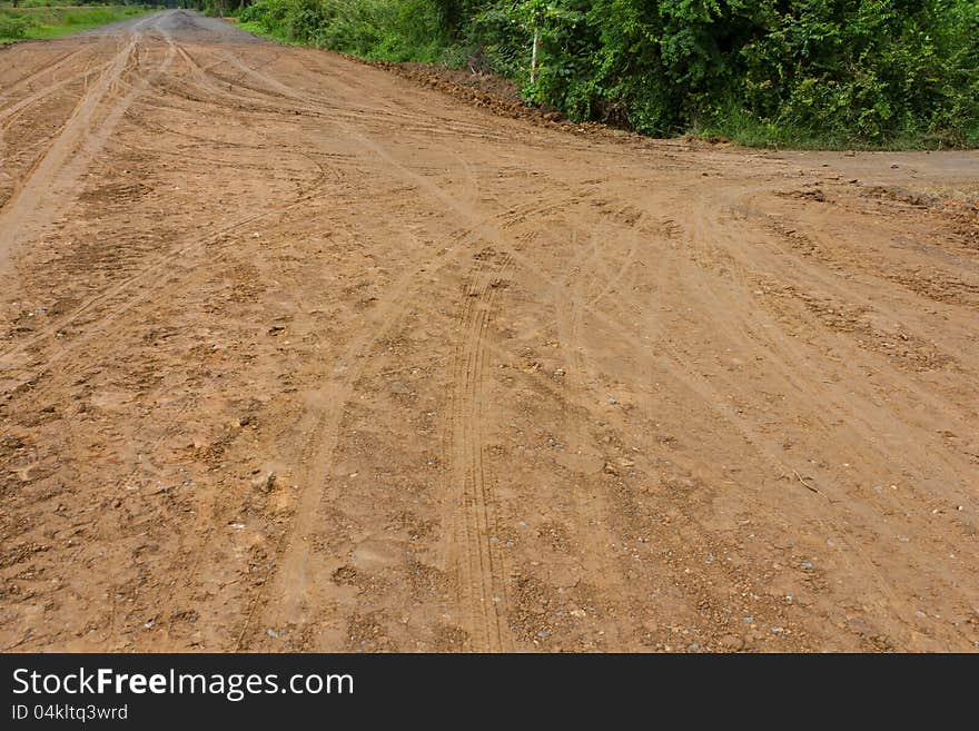 Traces of the wheels of cars and motorcycles on the roads in rural areas on the ground after a rain. Traces of the wheels of cars and motorcycles on the roads in rural areas on the ground after a rain.