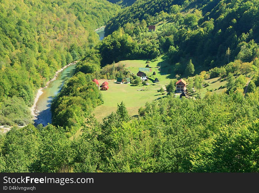 Houses in a meadow by the Tara river Montenegro. Houses in a meadow by the Tara river Montenegro