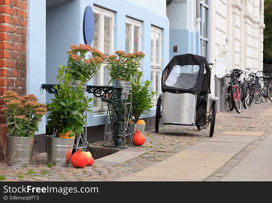 Tricycle parked outside a blue house in Copenhagen Denmark. Tricycle parked outside a blue house in Copenhagen Denmark