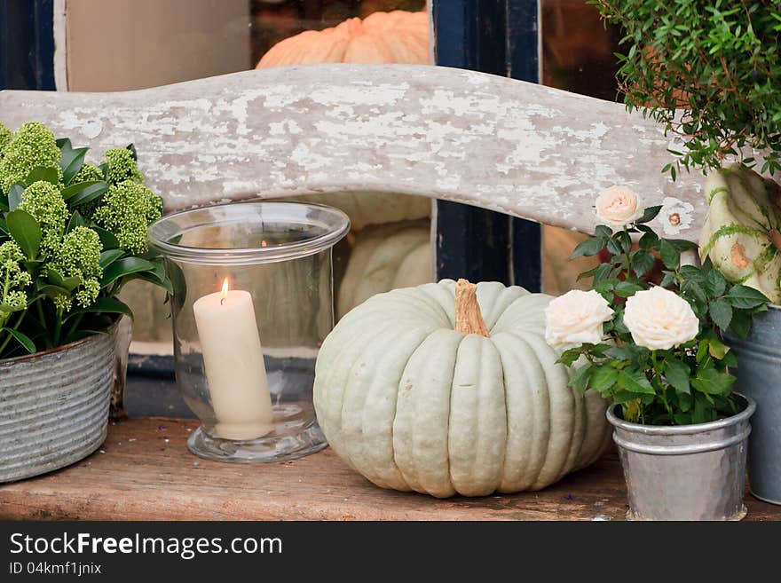 Burning candle and light green pumpkin. Burning candle and light green pumpkin