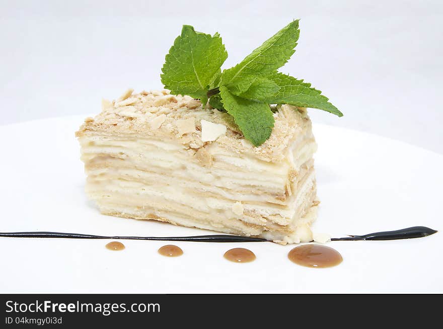 Layered dessert on a white background decorate with mint. Layered dessert on a white background decorate with mint