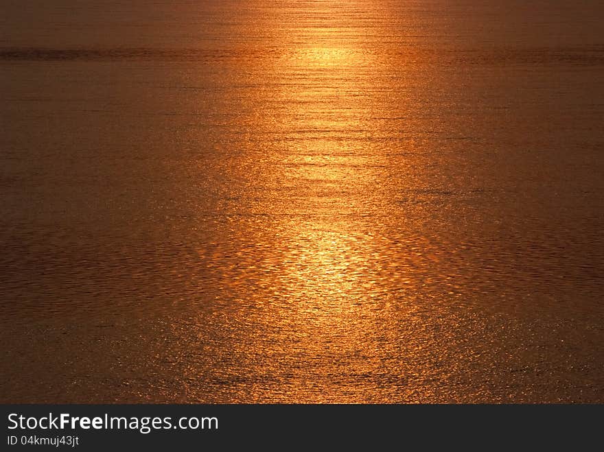 Sea water turns into golden by the reflection of sunset. Sea water turns into golden by the reflection of sunset