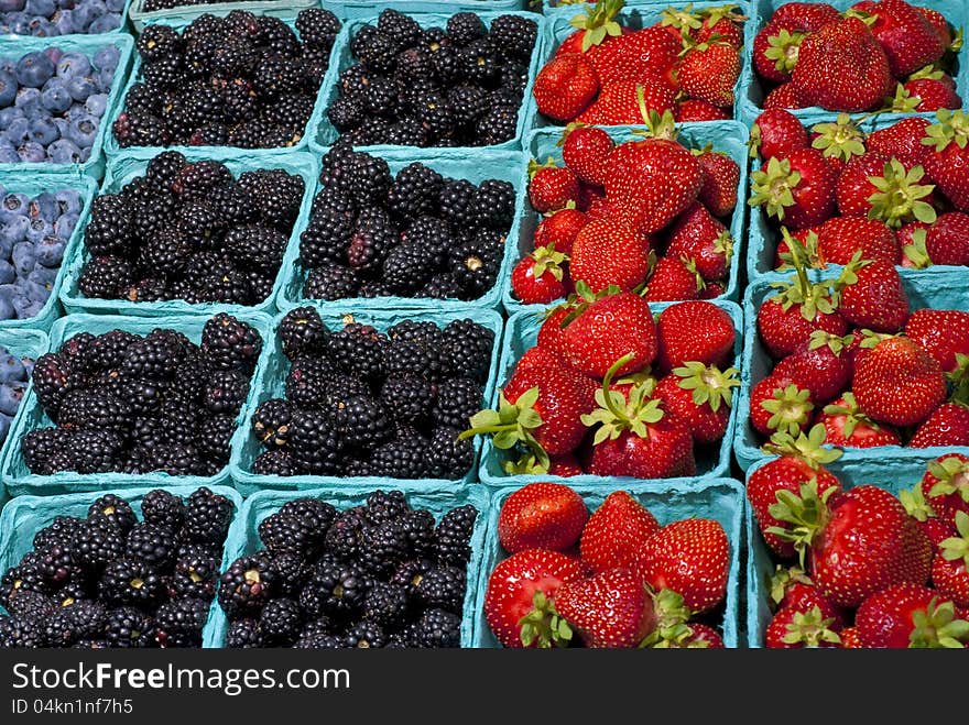 Many berries on display at a market