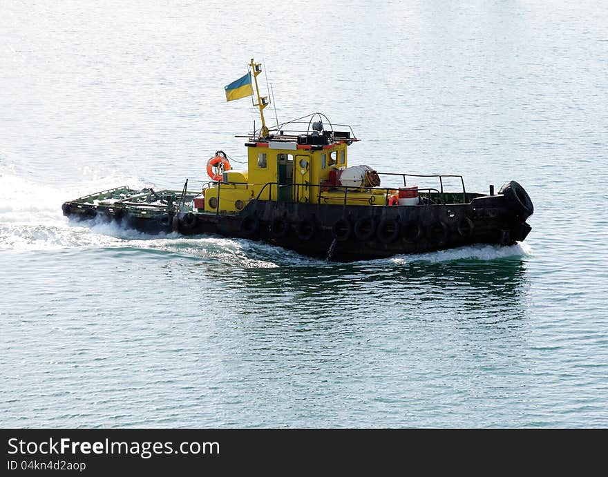 Speeding tug boat in area of harbour. Speeding tug boat in area of harbour