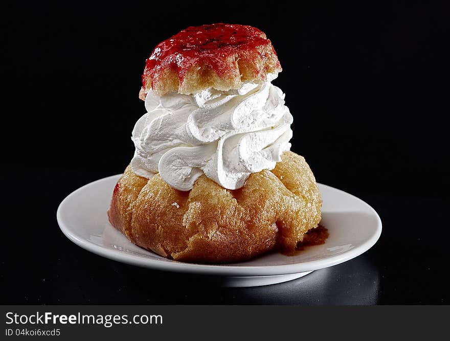 Rum baba with cherry syrup