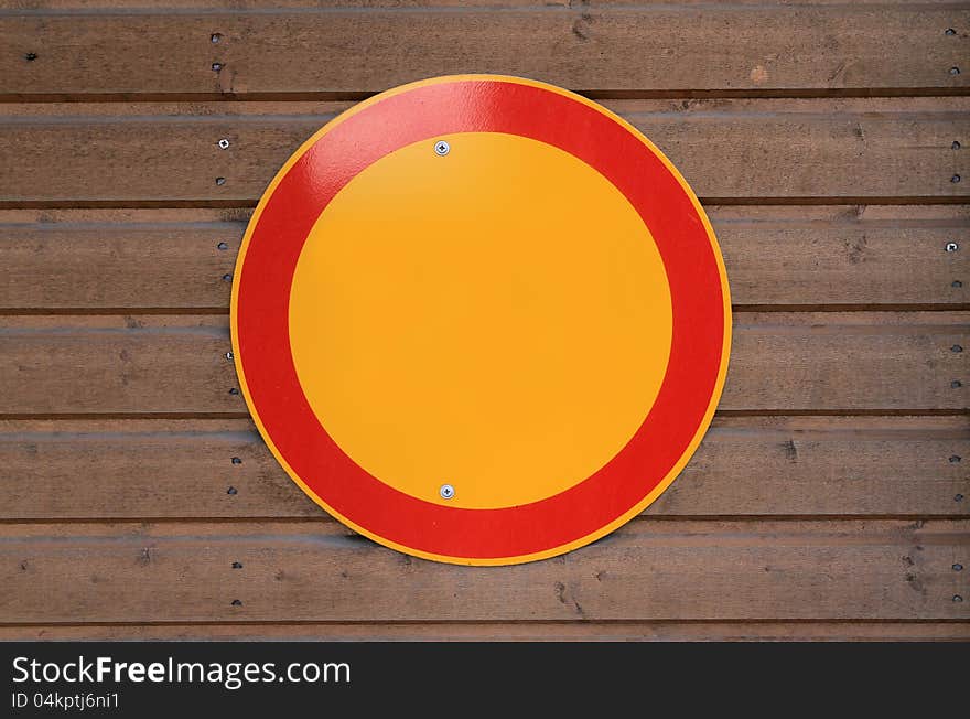 Blank yellow sign with red boarder on wooden wall. Blank yellow sign with red boarder on wooden wall.