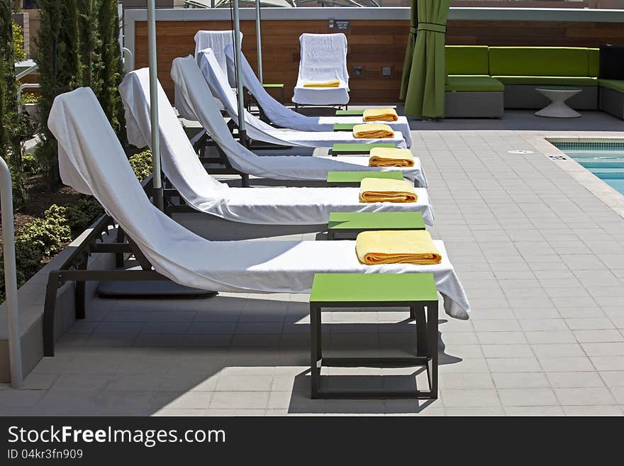 Poolside deck chairs prepared for sun bathers