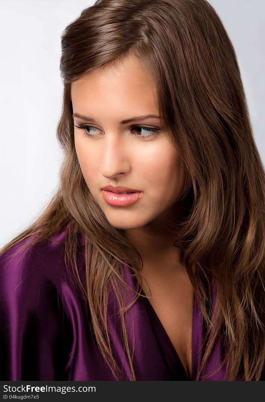 An image of a beautiful teenage girl in a purple satin top. An image of a beautiful teenage girl in a purple satin top