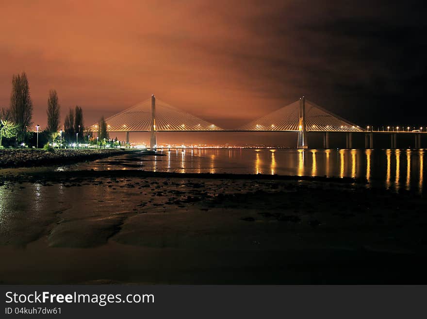 Night view of a bridge on a river in Lisbon. Night view of a bridge on a river in Lisbon