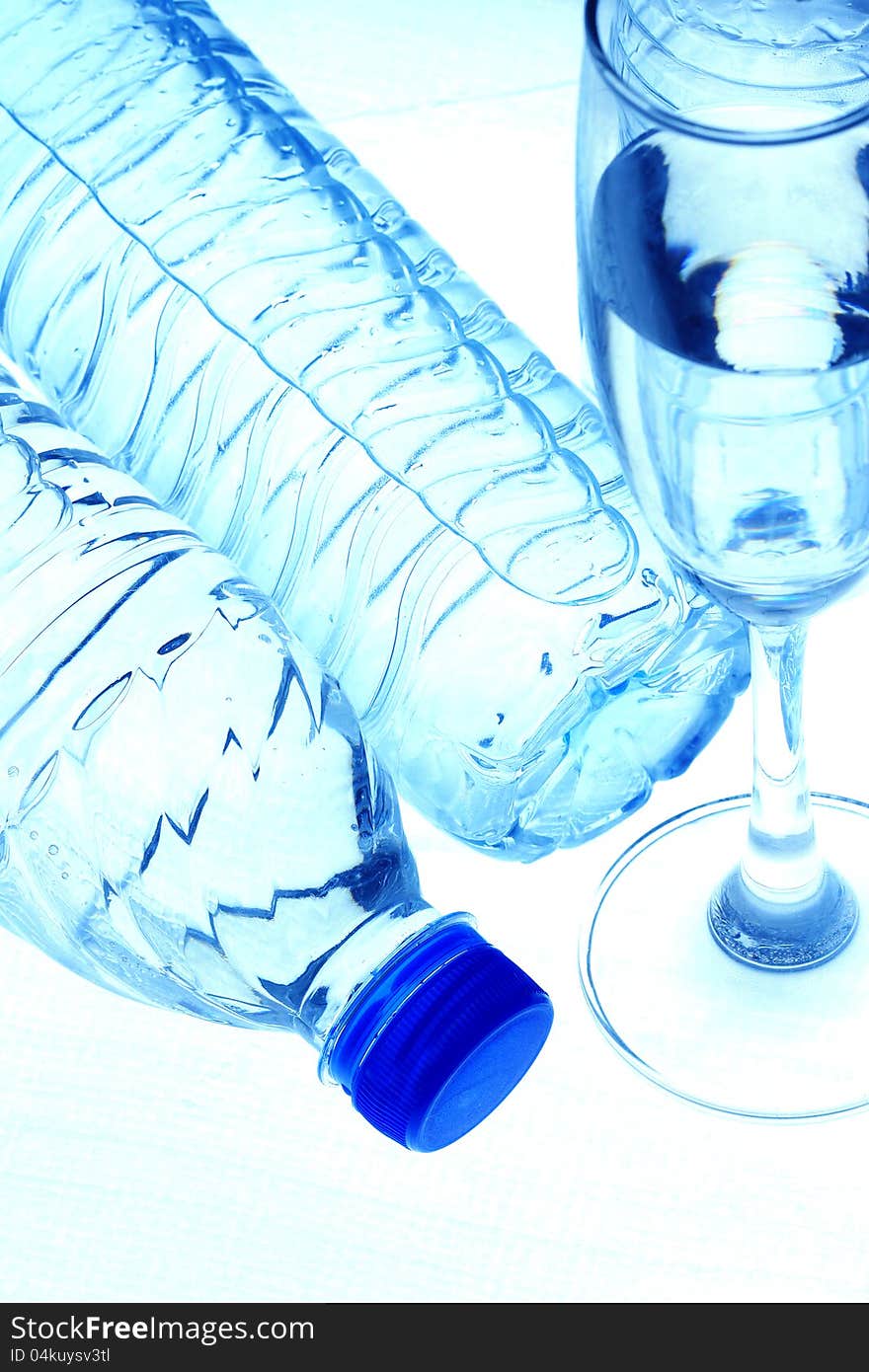 Bottles contain pure water  and glass on white background