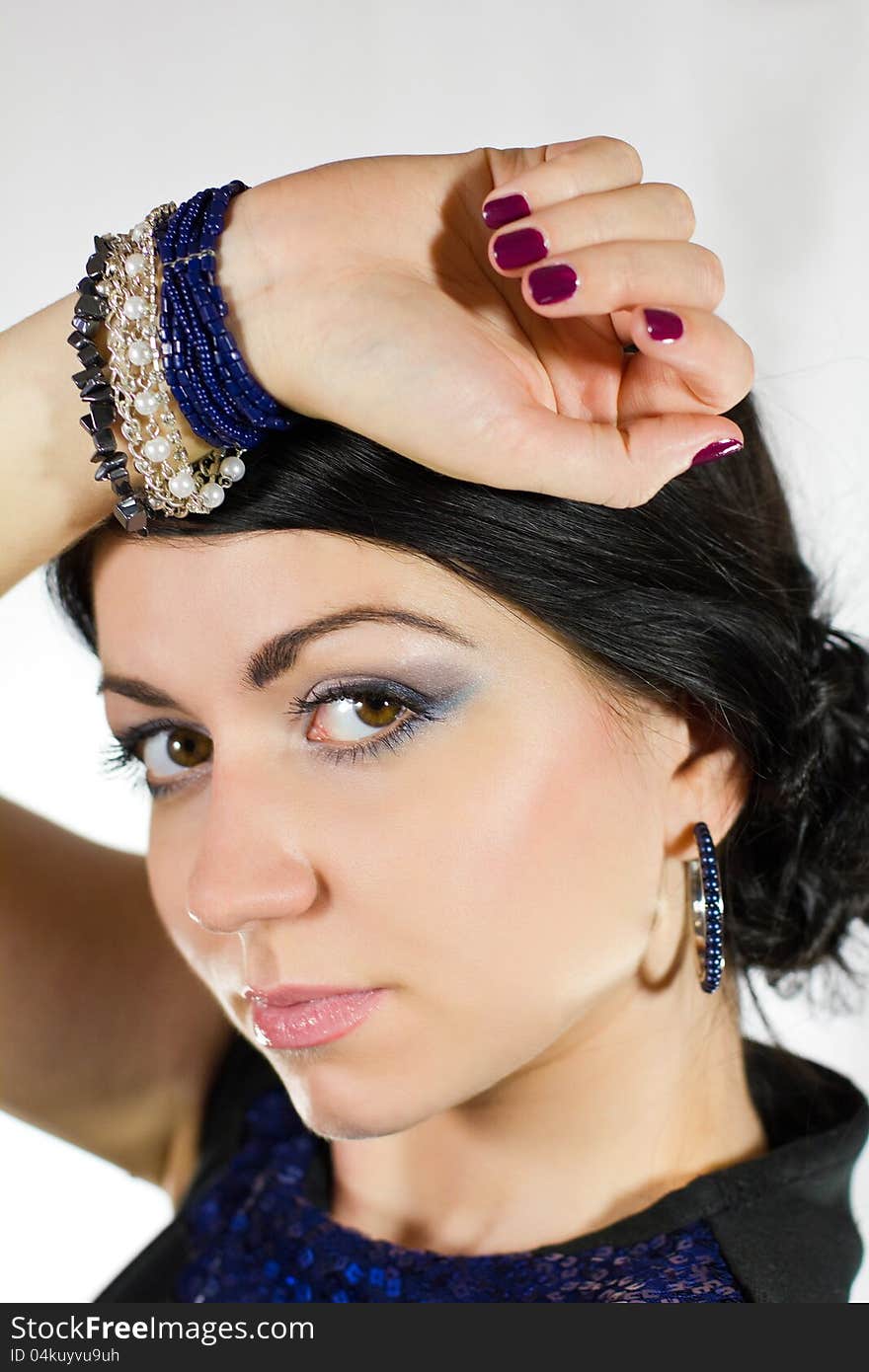 Portrait of beautiful young brunette woman in blue dress and bracelet. Portrait of beautiful young brunette woman in blue dress and bracelet