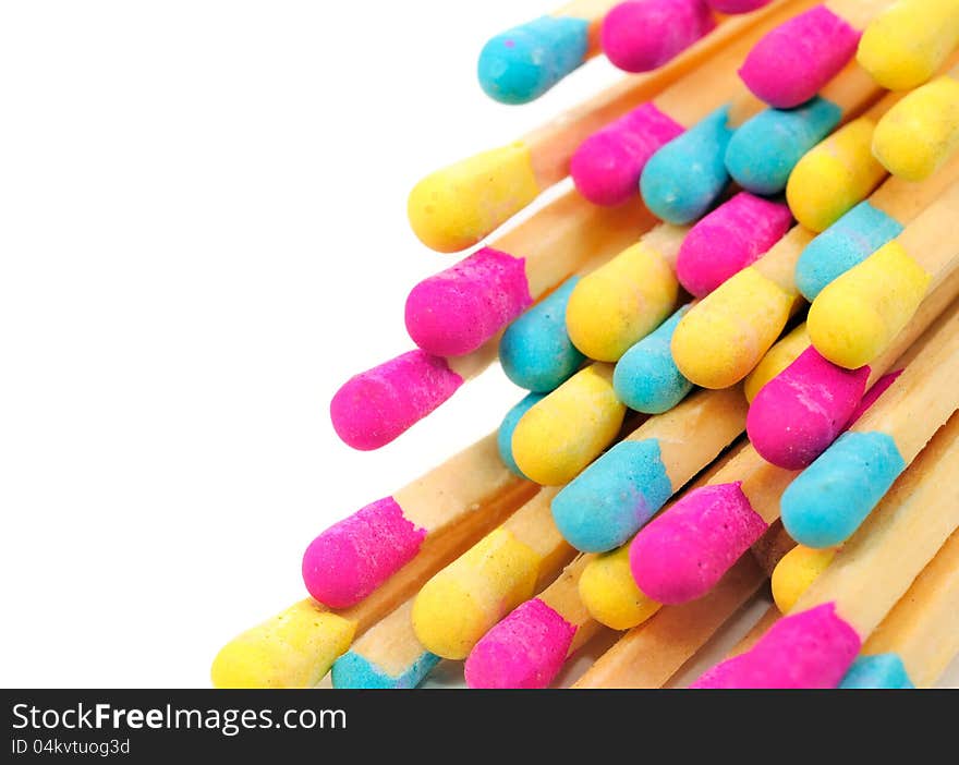 A bunch of multicolored matches on a white background with copy space. A bunch of multicolored matches on a white background with copy space