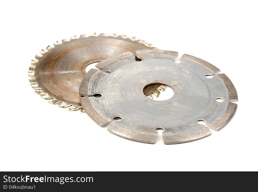 Two used circular saw blades on a white background