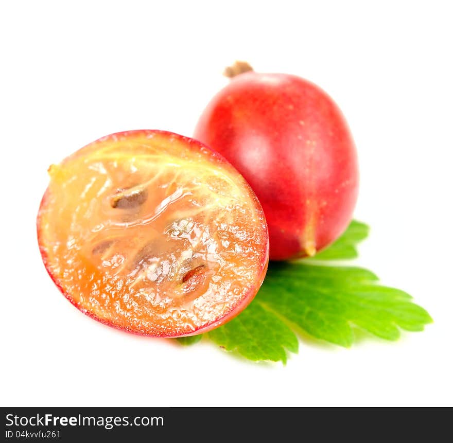 A whole gooseberry and a gooseberry cut in half with a green leaf isolated on a white background. A whole gooseberry and a gooseberry cut in half with a green leaf isolated on a white background