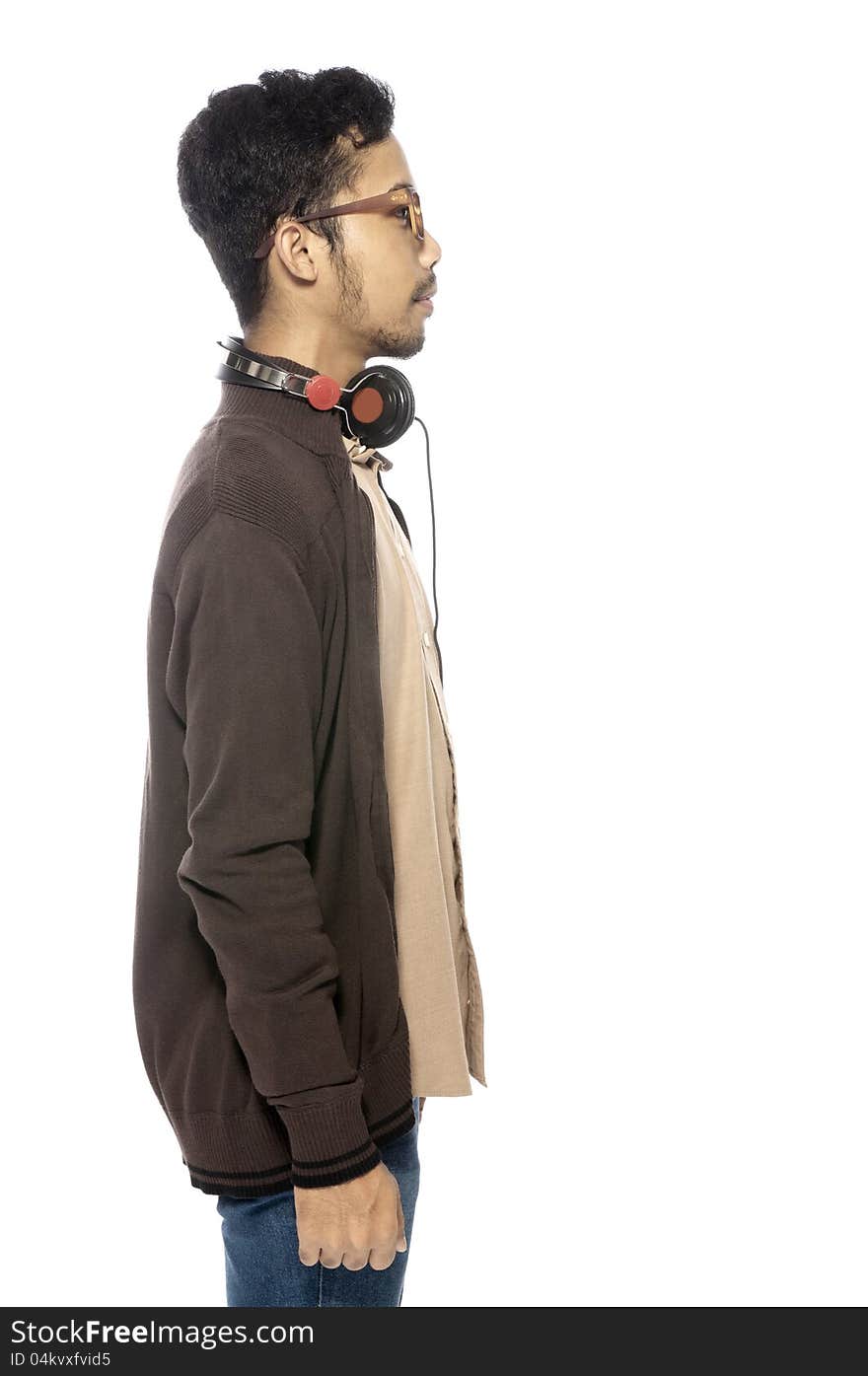 Handsome young man listening to music using headphone. Handsome young man listening to music using headphone