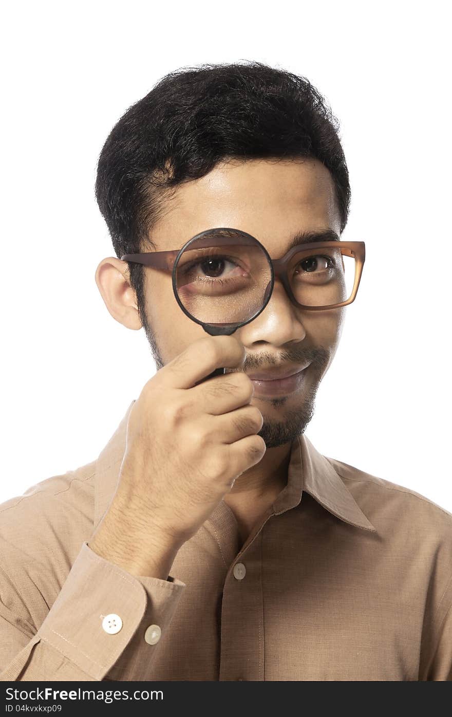 Funny young man looking through magnifying glass, isolated on white. Funny young man looking through magnifying glass, isolated on white