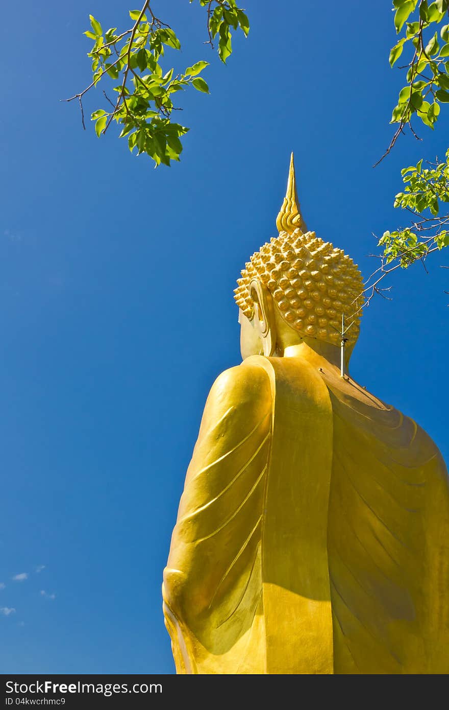 Big Golden Buddha statue with blue sky at tham khao tao temple,thailand