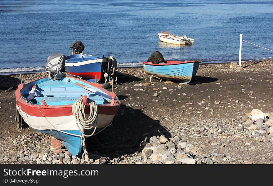 Colorful wooden fishing boats pulled ashore