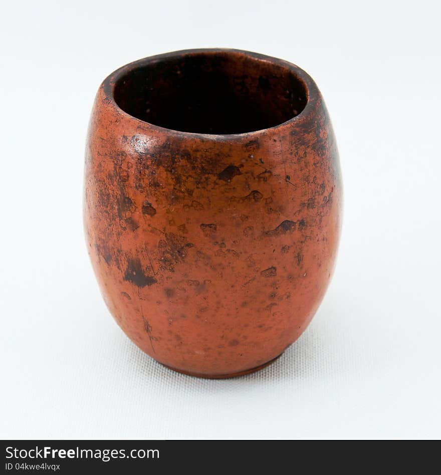 Ancient cup from ceramics on a white background