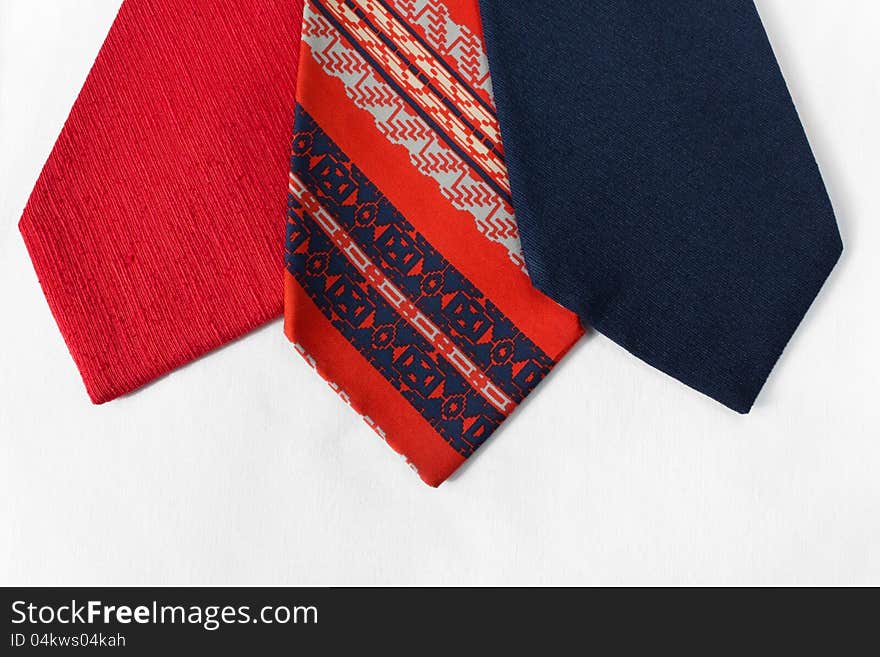 Neckties of various colors with a white cloth as background. Neckties of various colors with a white cloth as background