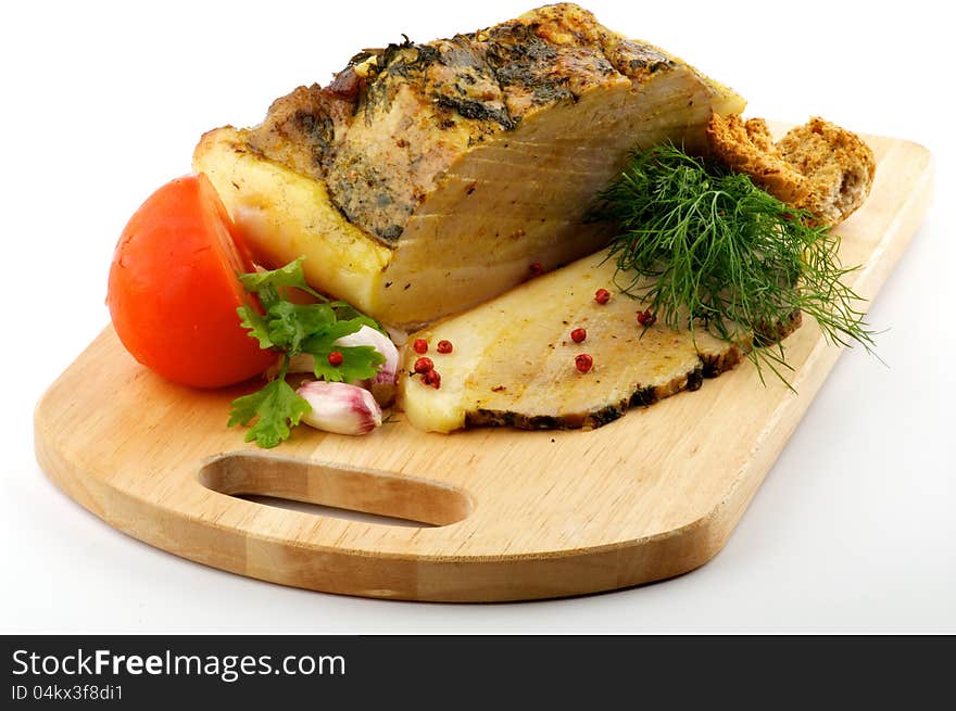 Homemade Roast Pork with Dill, Parsley, Garlic and Tomato on wooden cutting Board