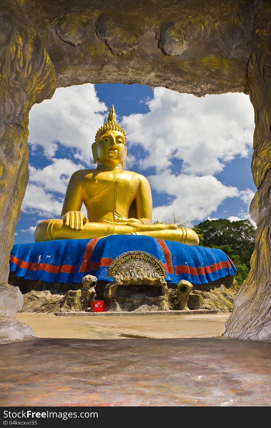 Big Golden Buddha statue with blue sky at tham khao tao temple,thailand