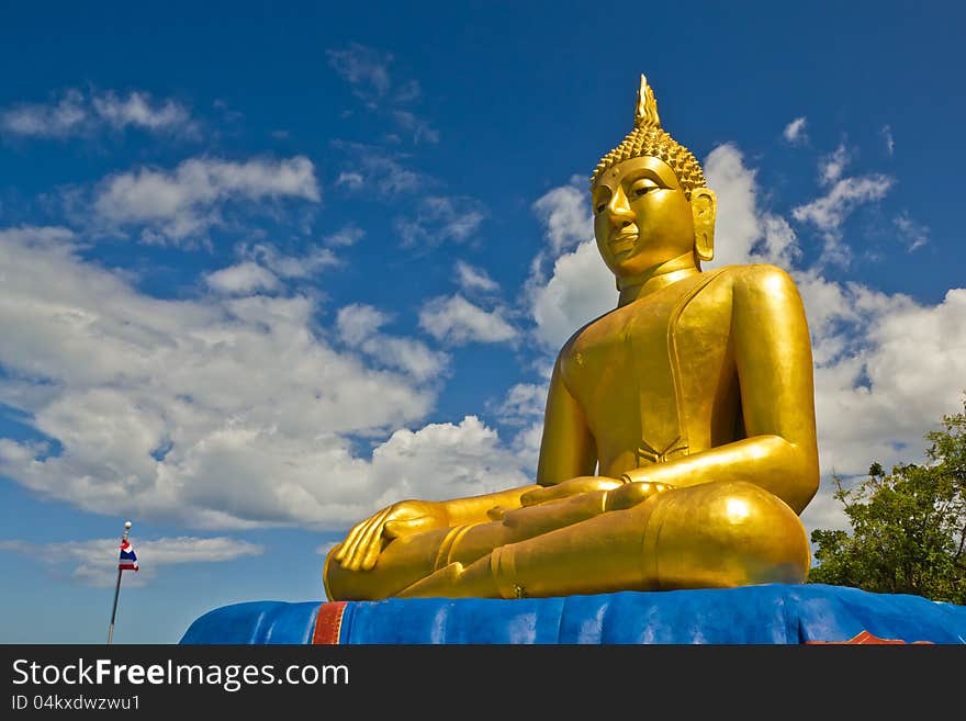 Big Golden Buddha statue with blue sky at tham khao tao temple,thailand