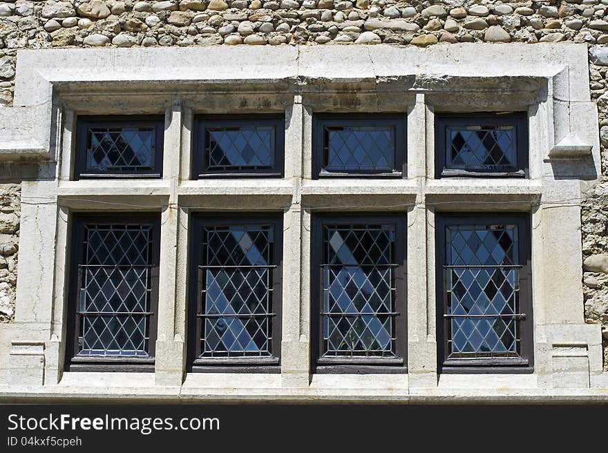 Very old window with grid and wall