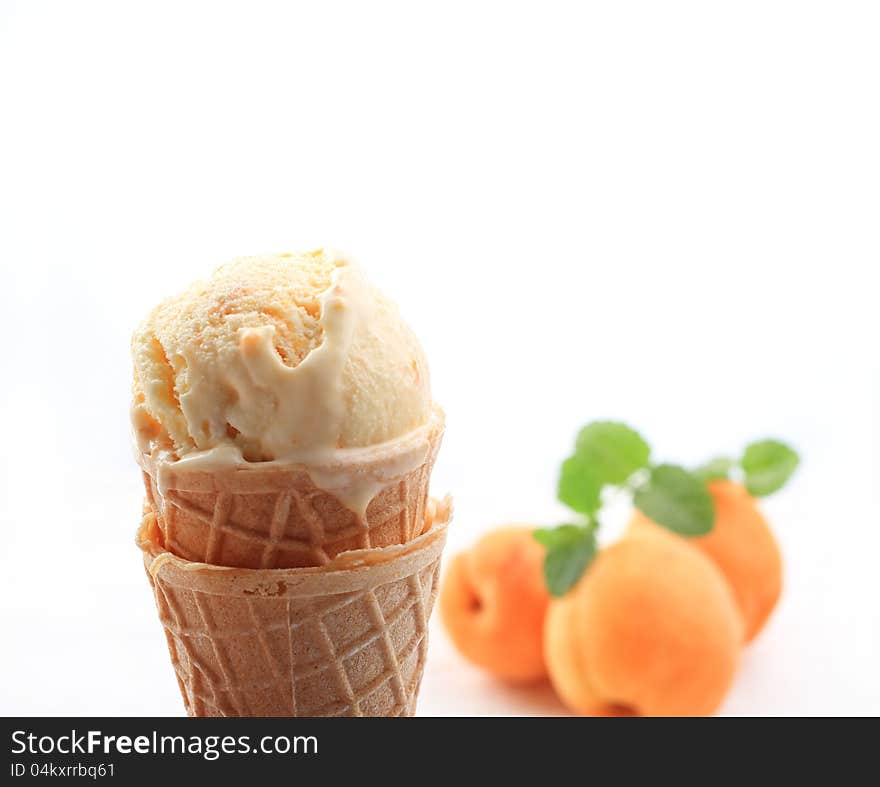 Apricot ice cream with cone on white background