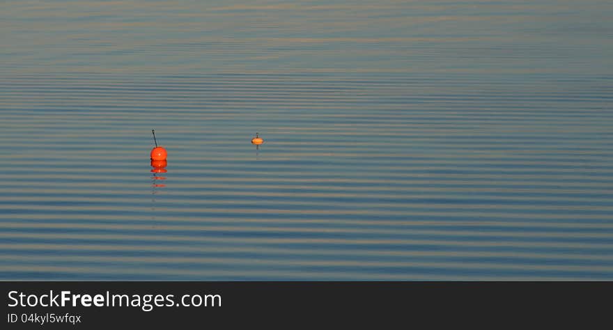 Two buoys on water ripples