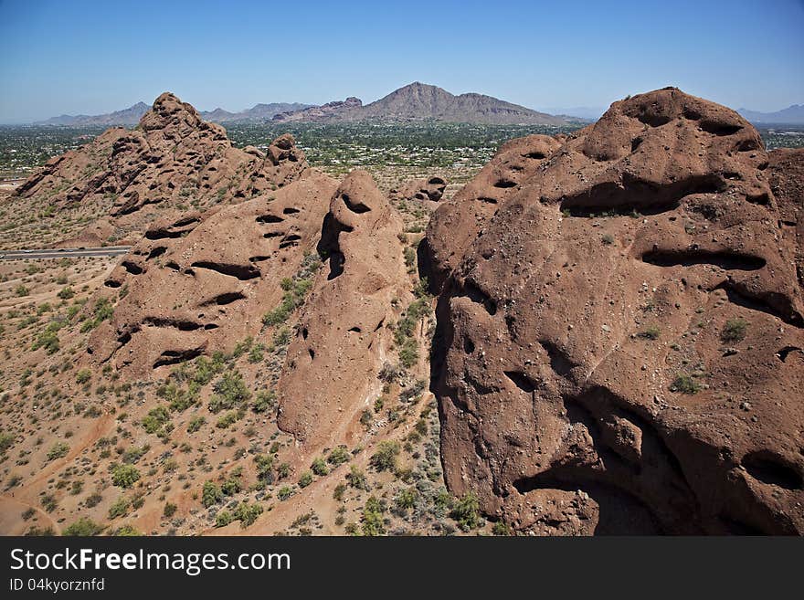 Aerial view of the red rocks in Papago Park with Camelback Mountain in the distance