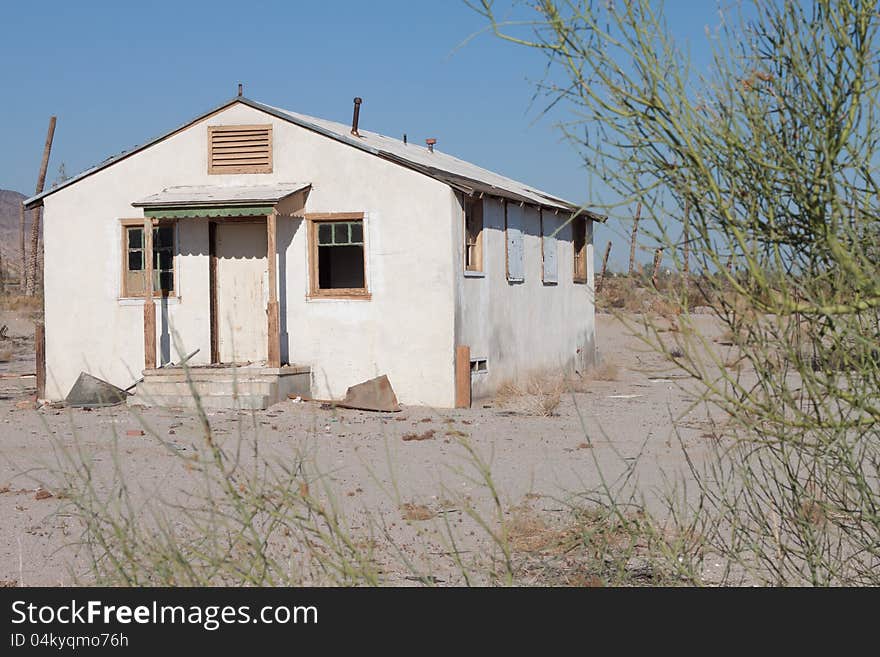 An old white abandoned house in the desert