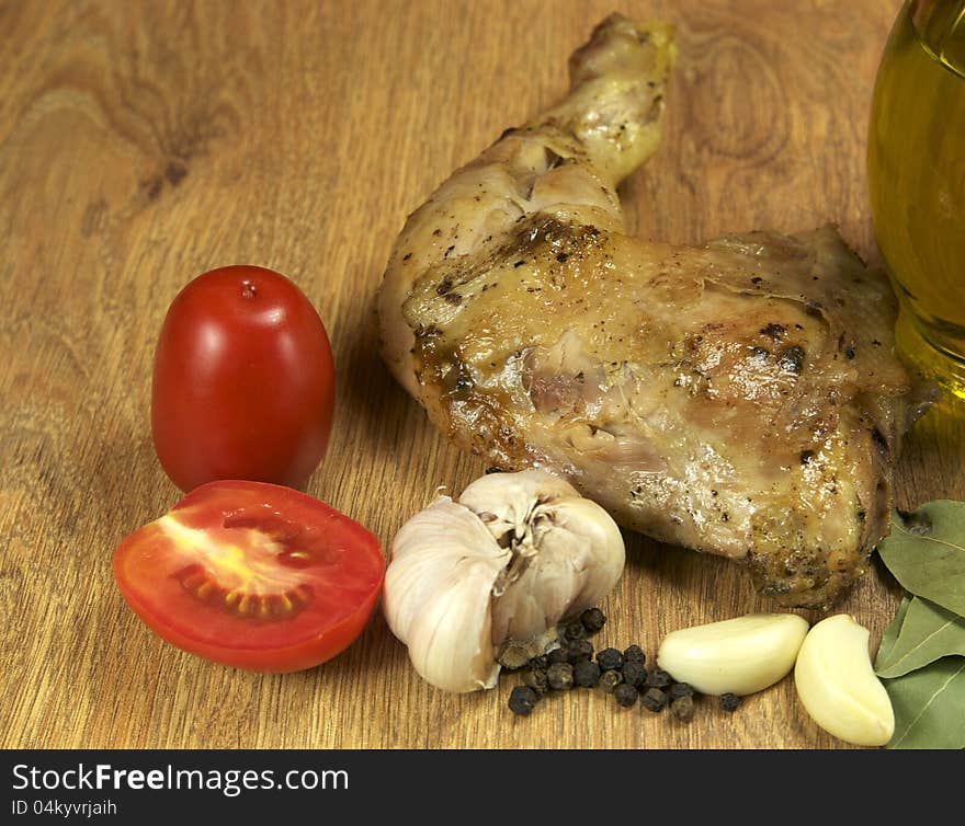 Chicken leg with pepper and butter on a wooden table. Chicken leg with pepper and butter on a wooden table