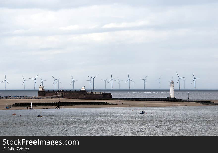 New Brighton Lighthouse and wind turbines on the horizon. Liverpool area, England.