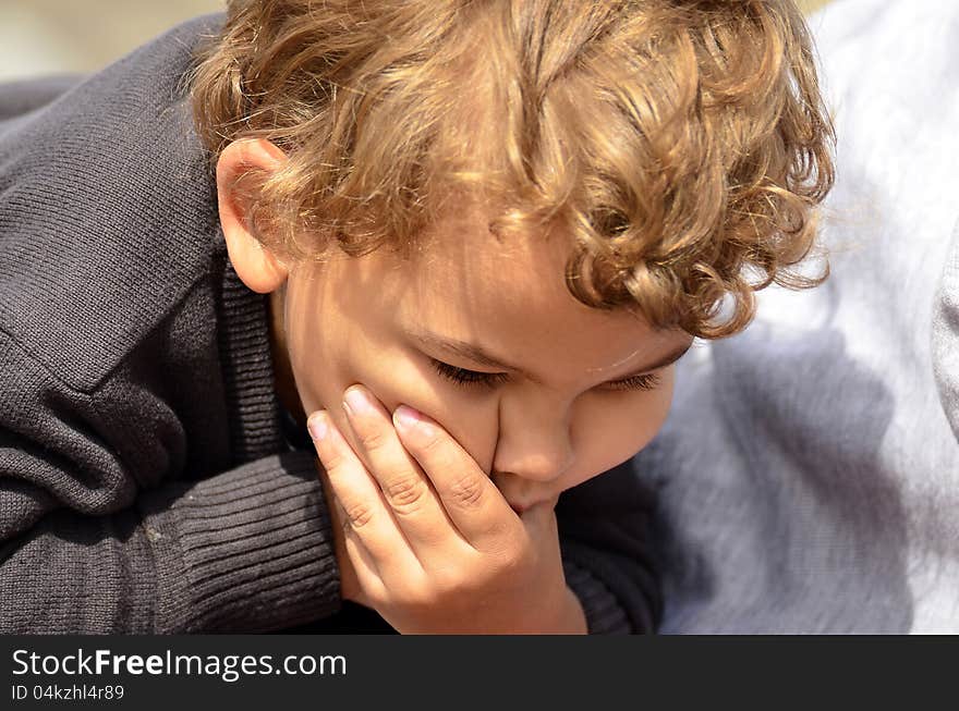 Boy making a funny face with hand