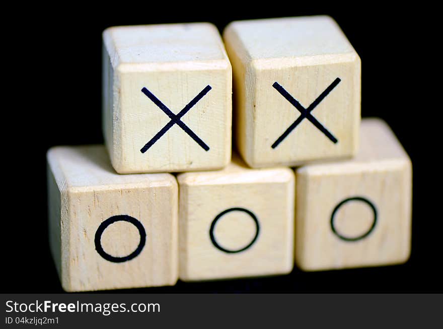 Wooden boxes with sign x and o on them.