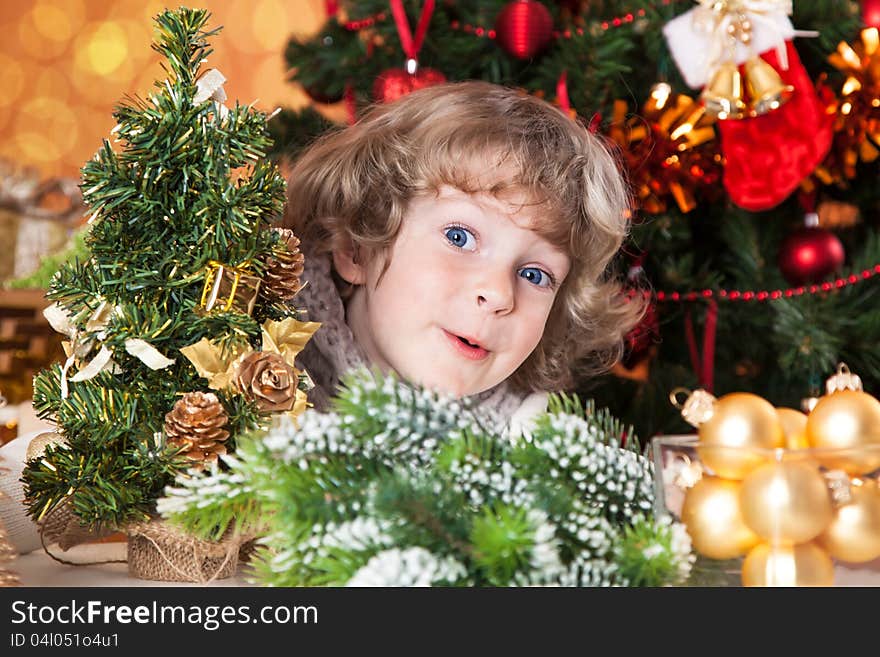 Happy child having fun against Christmas tree with decorations