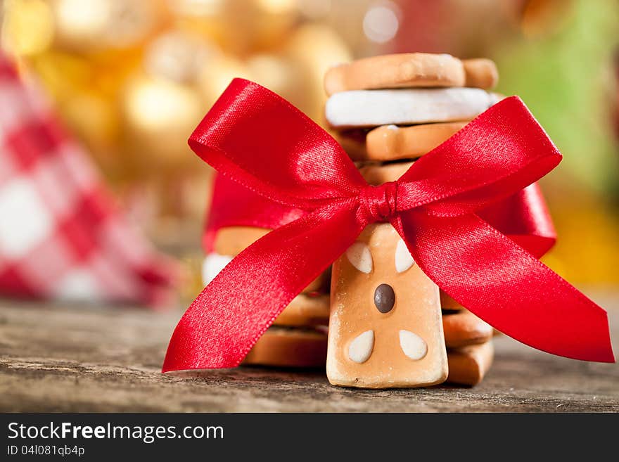 Cookies with red bow against Christmas lights