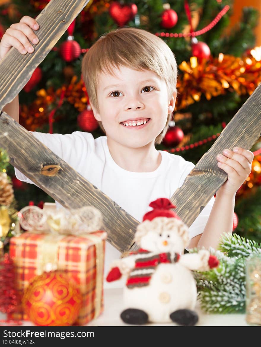 Happy boy playing against Christmas lights background. Happy boy playing against Christmas lights background